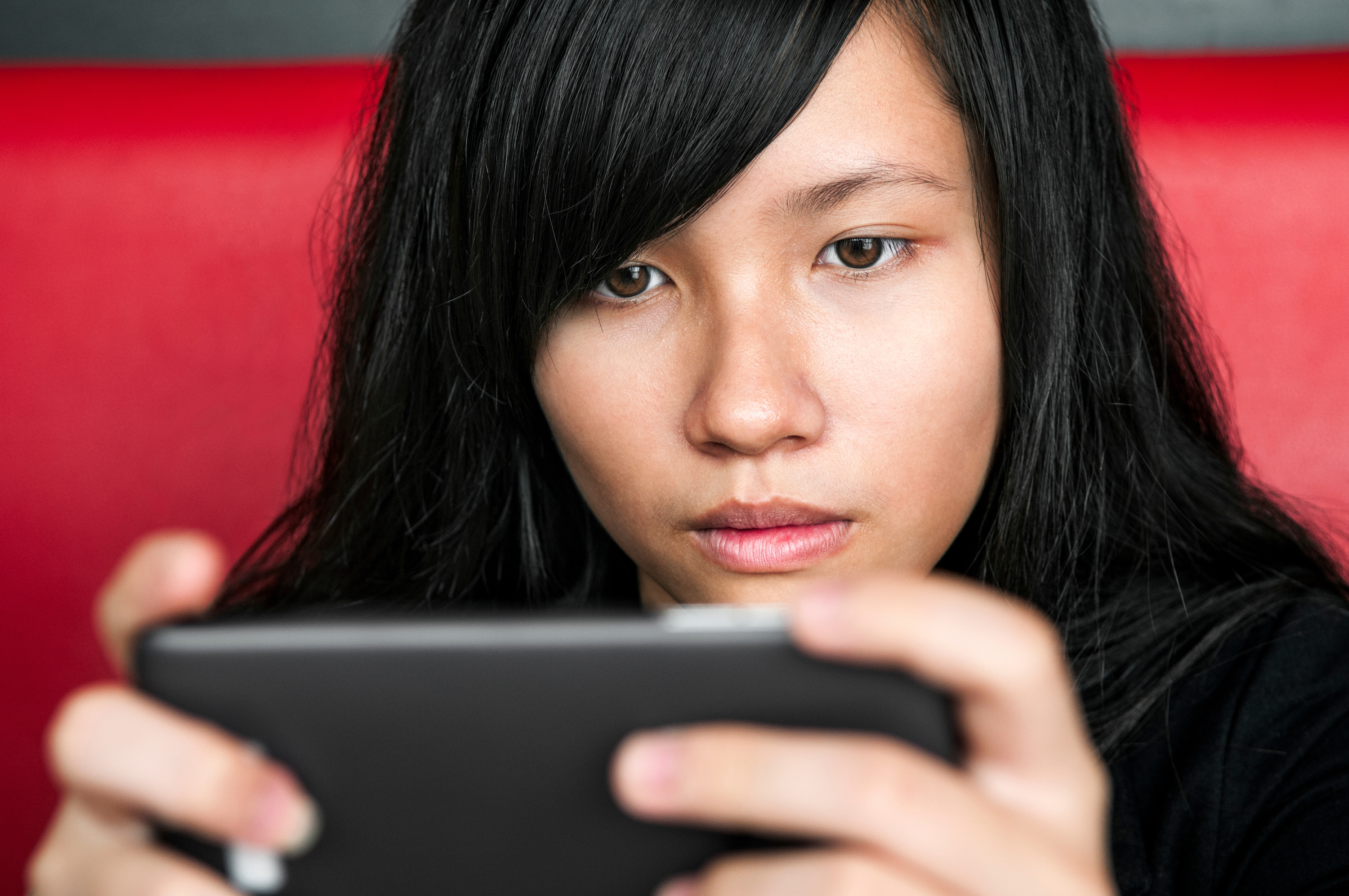 Asian girl student using mobile phone